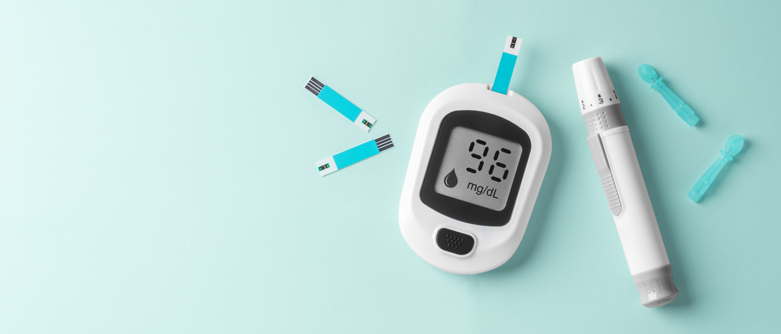 Blood glucose meter, diabetes checking sugar level on light green background, top view